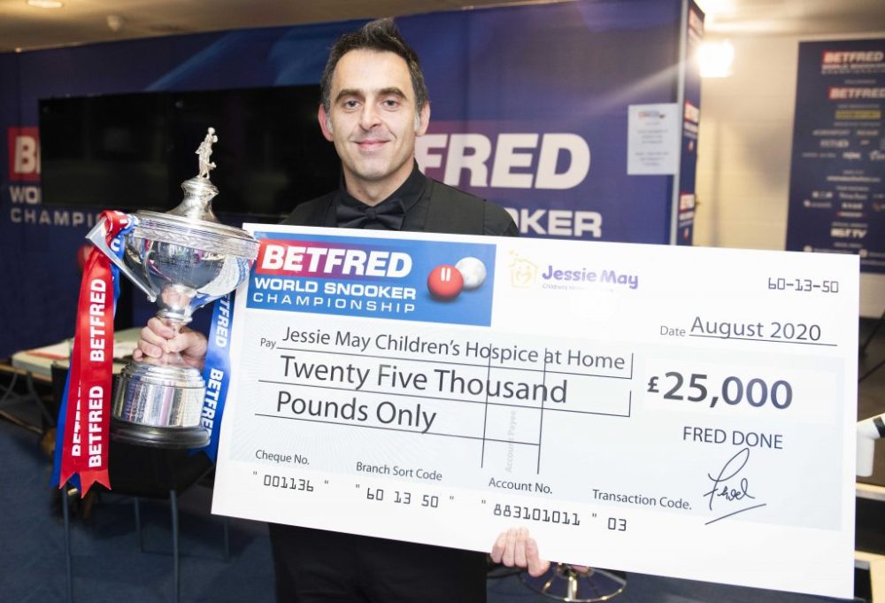 Ronnie O'Sullivan accepts a £25,000 cheque on behalf of Jessie May