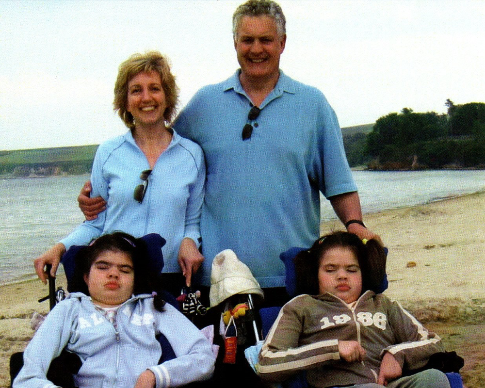 Family of four standing on a beach